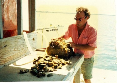 Martin Ceely culling oysters on the barge